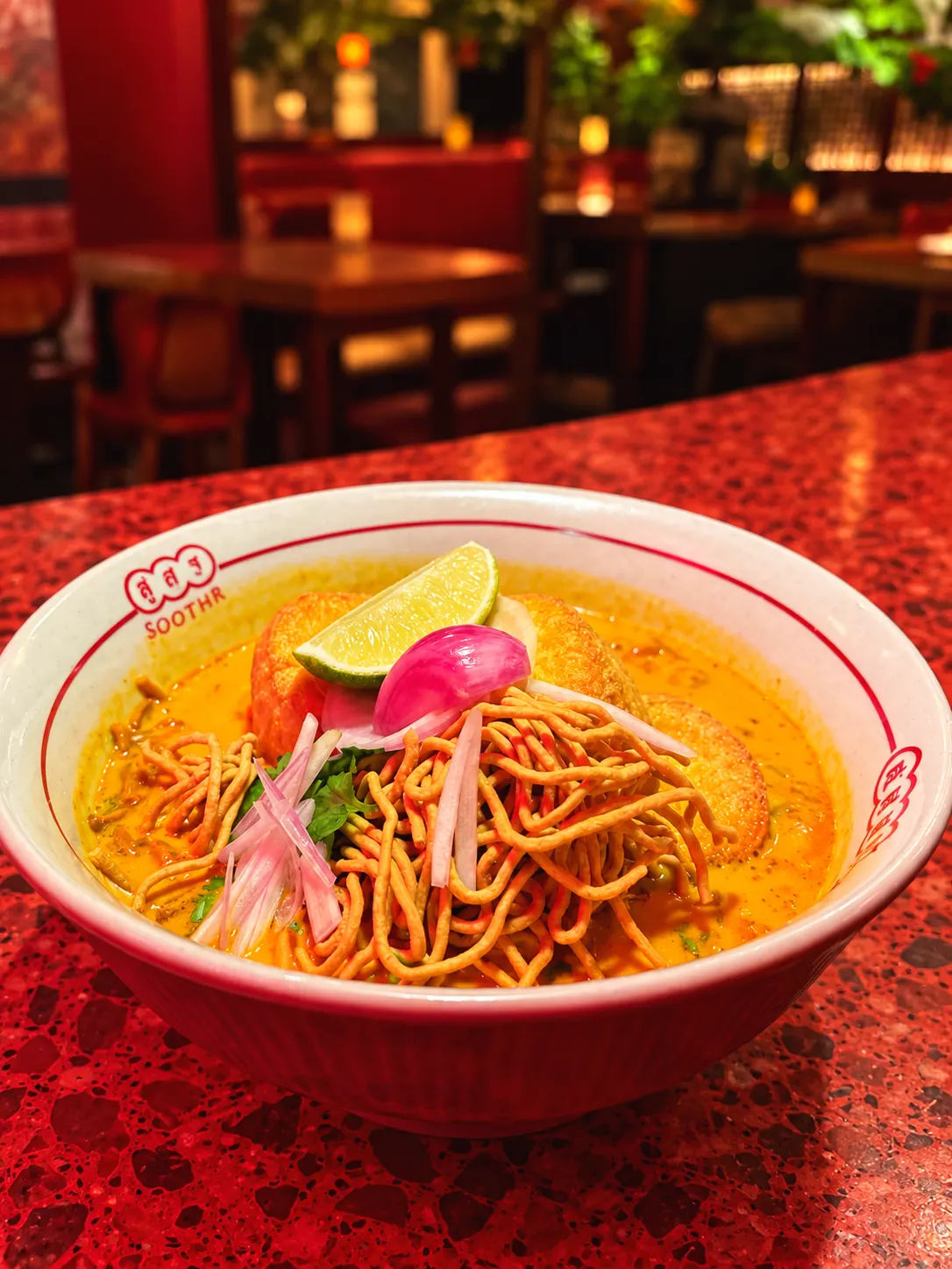 Khao Soi with tofu, crispy noodles and a lime wedge